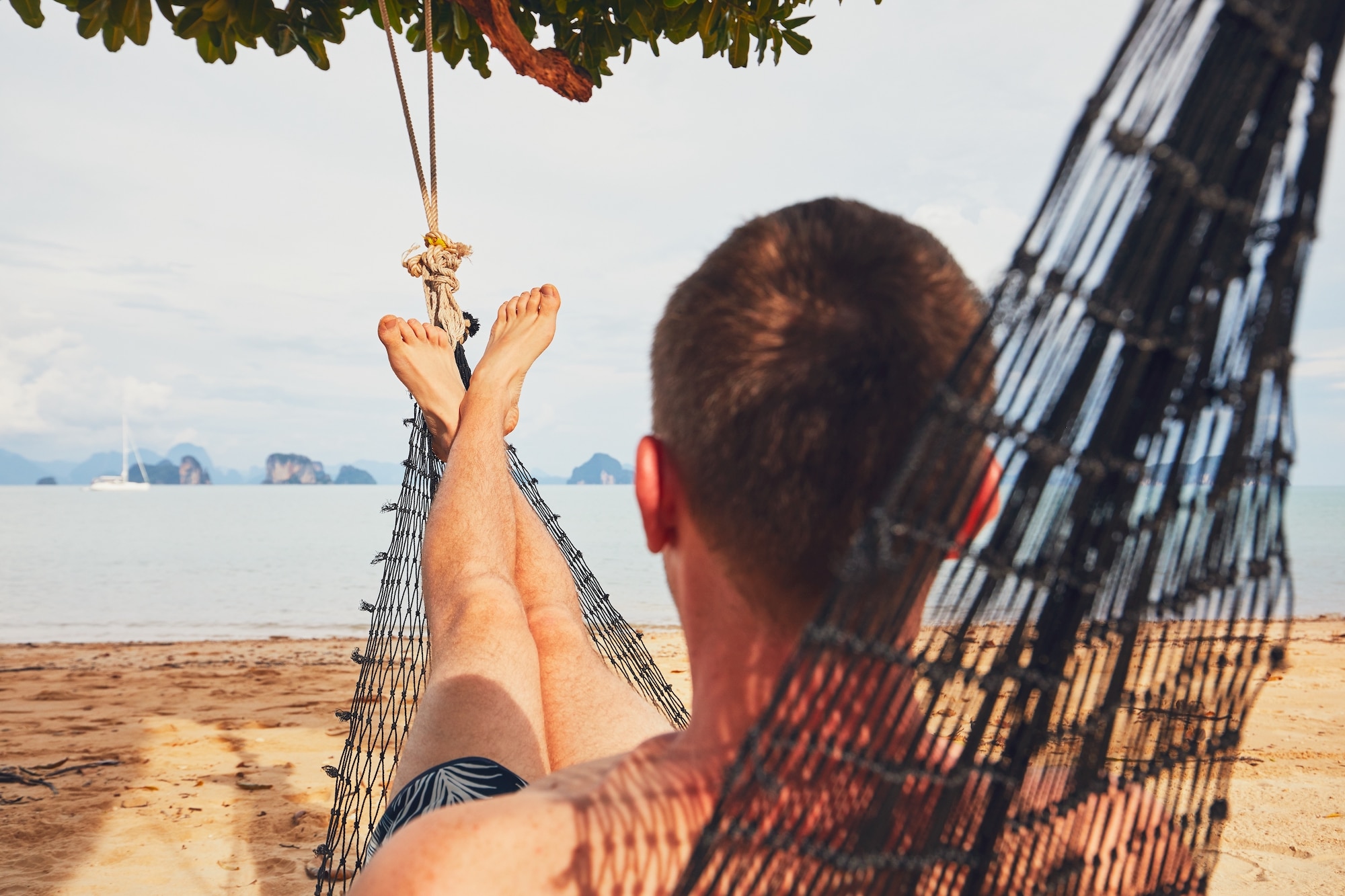 man relaxing in a hammock